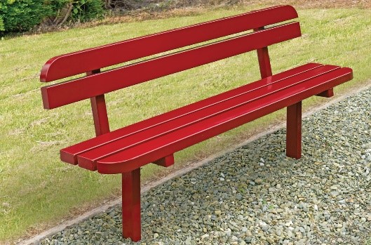 Red steel bench with horizontal slats for sitting on and for back support. The slats at the front of the seat and the top of the back support have rounded ends.